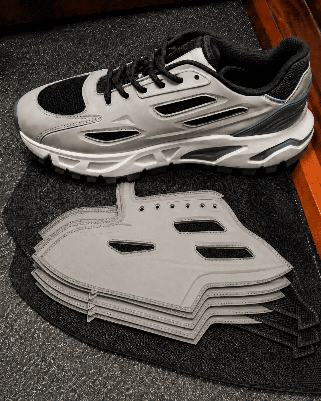 Quality control inspector reviewing molded uppers under inspection lighting